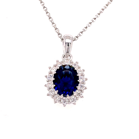 Sterling Silver Oval Blue CZ Pendant with White CZ Halo