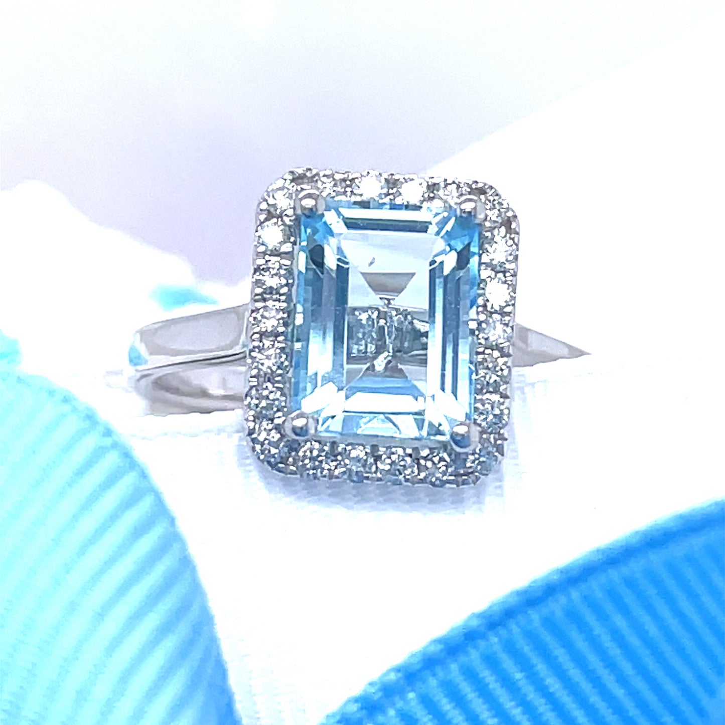 9ct White Gold Emerald Cut Halo Blue Topaz And Diamond Ring .25